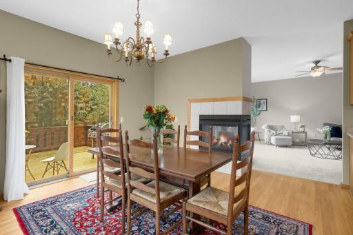 The three-sided gas fireplace is a standout feature, positioned between the Dining and Living Rooms so it can be enjoyed from both spaces. The patio door provides convenient access to the secluded backyard deck.