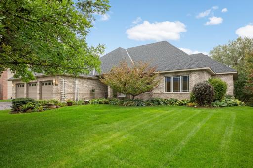 Beautiful all-brick front gives this spacious rambler wonderful curb appeal, complemented by mature landscaping, a lush lawn and an attached 3-car garage. A new roof was installed in 2026.