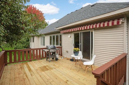 New deck boards give this large outdoor space a fresh update! Plenty of room for grilling, entertaining or simply enjoying the surrounding trees. There is also a sun setter shade that cranks out.