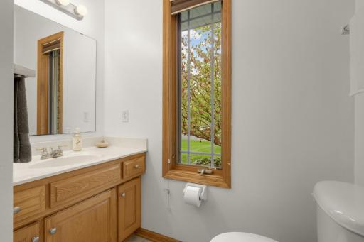 Additional Bath offers convenient vanity storage and a window for natural light.
