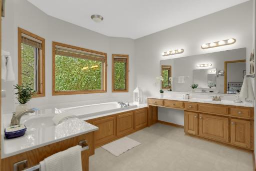 Large private Ownerâs Bath with a jetted tub surrounded by windows - a relaxing spot with beautiful views of the trees!