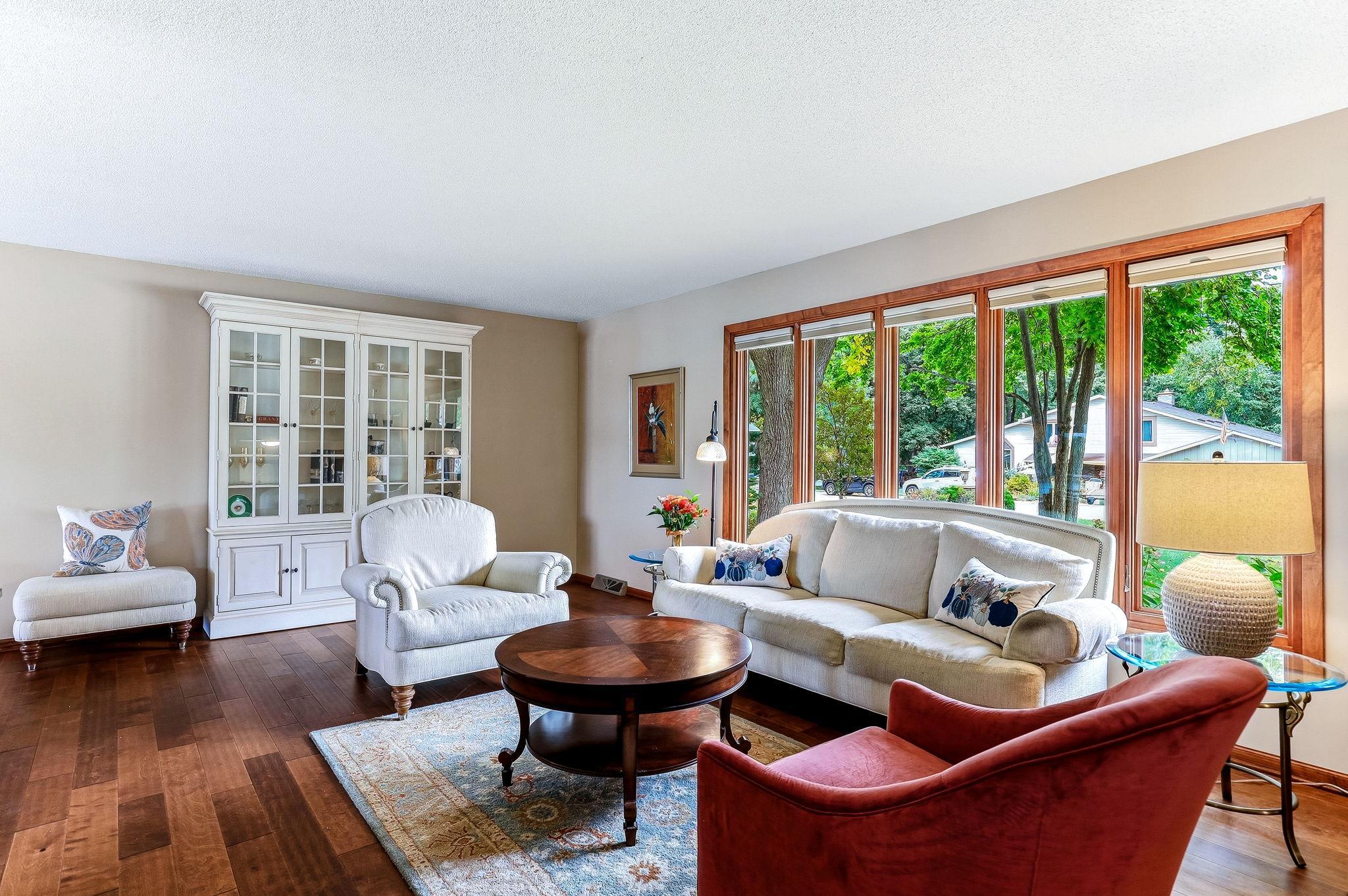 Main living room with large picture windows bringing plenty of natural light