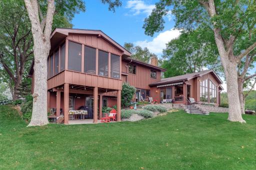 View of the backyard leading to garden beds and the dueling patio areas