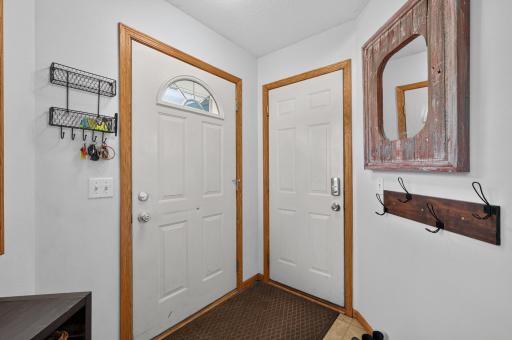 Front entry door to the left and garage door to the right.