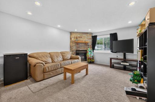 Lower level living room has a gas fireplace.