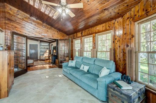 Relax and unwind in this vaulted four-season porch surrounded by incredible lake views!
