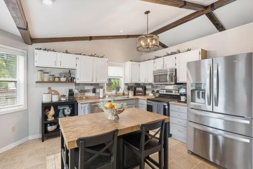 Stainless appliances, island, and bay window for added light.