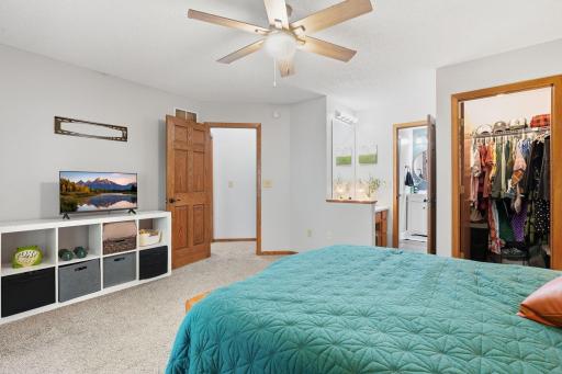 Primary bedroom with vanity, walk-in closet, and walk though to connected bathroom.