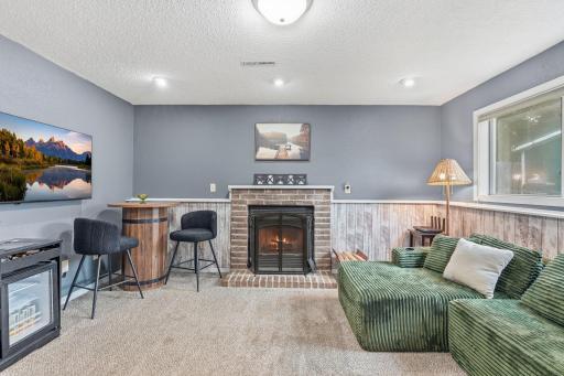 Lower level features cozy family room with gas fireplace, updated 3/4 bathroom, and 4th bedroom.