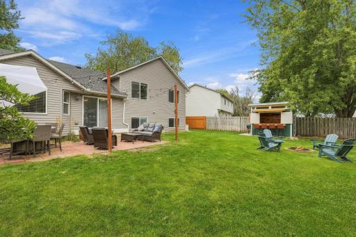 Large yard with patio, fire pit and a versatile storage shed. This space was built for relaxing.