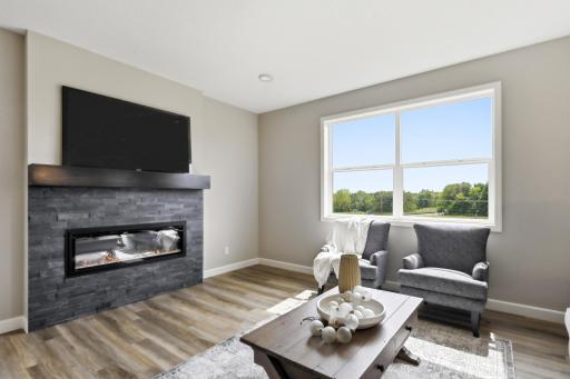 Electric fireplace with stone and mantel accents. *photos taken of previously completed home, not all finishes & options the same.*
