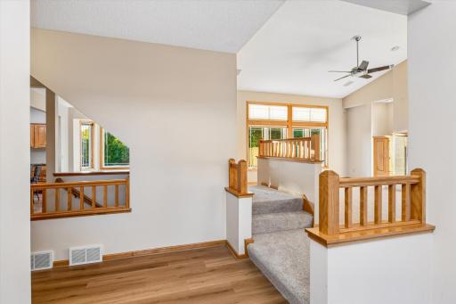 Here's the view from the foyer straight ahead- there is a custom-built view into the kitchen & dining, as well as stairs around to the kitchen & upstairs.