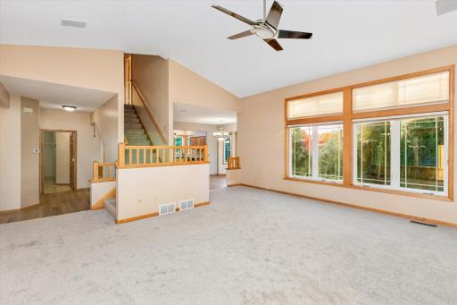 Step up into the vaulted great room with many windows with transoms above- these are facing the back yard facing west