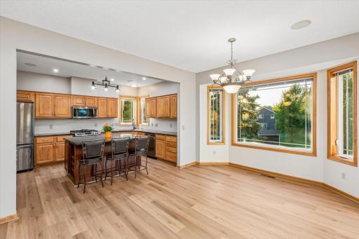 This dining room (with brand-new vinyl/plant flooring) joins the spacious kitchen.