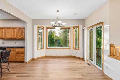 From the great room, step into this very spacious dining area with bay window facing the backyard & patio door.