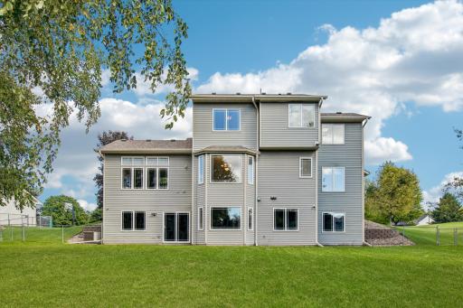 Here's a view of the back of this terrific home, showing the bay windows in the dining room & future family room with walk-out also.