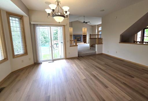 Another view from dining, showing the great room, and staircase to the right, with view into the foyer.
