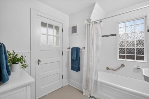 Upper bath with door to flat garage roof.