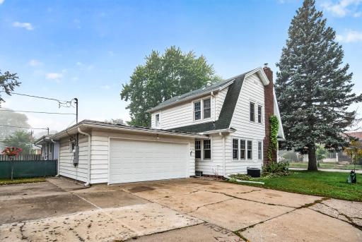 Attached garage, parking pad, driveway to boot!