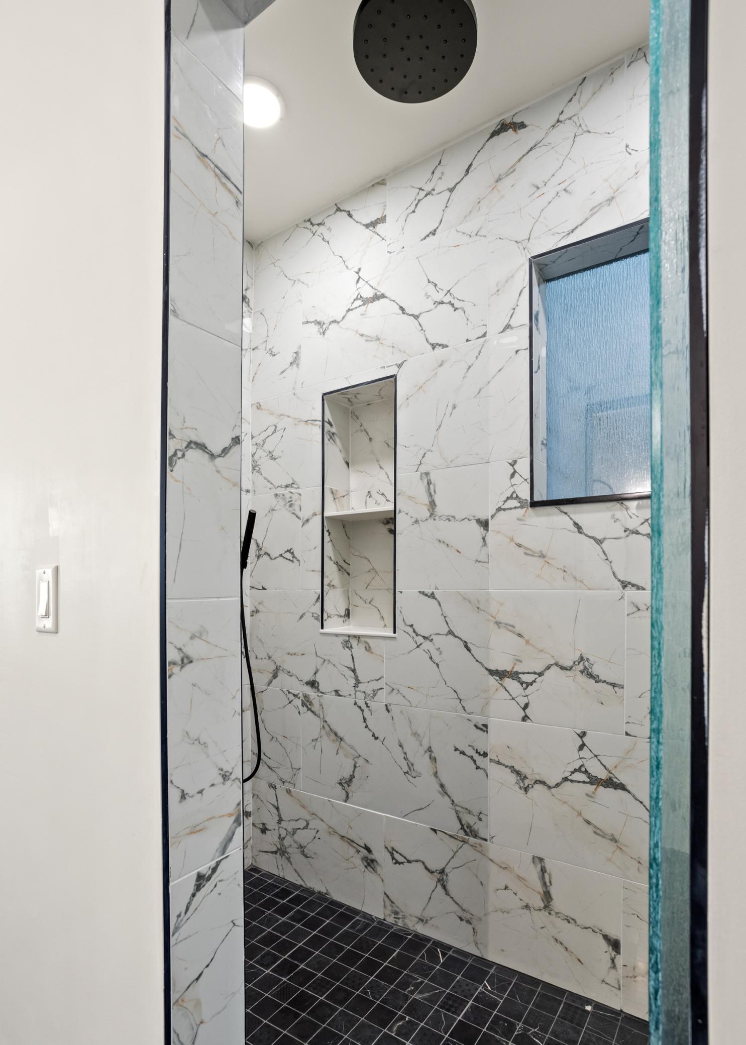 Walk in tiled shower primary bath