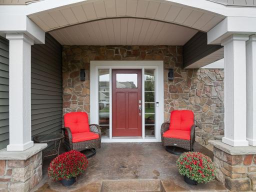 Front Porch â Welcoming covered front porch accented by stonework and a distinctive arched entry.