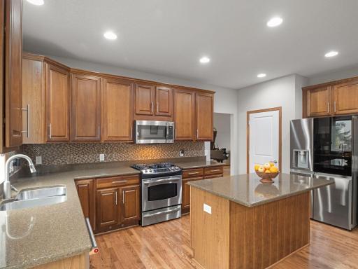 Kitchen â Center-island kitchen offers excellent cabinet and counter space along with stainless steel appliances.