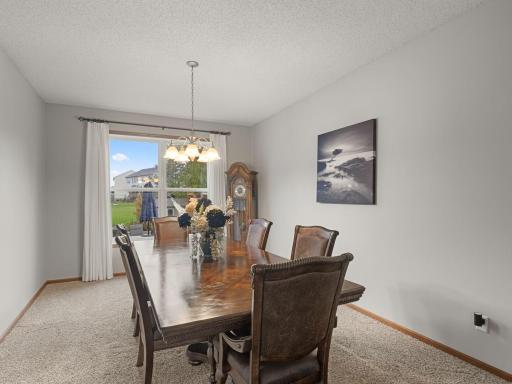 Formal Dining Room â Spacious formal dining room with large window overlooking the backyard.