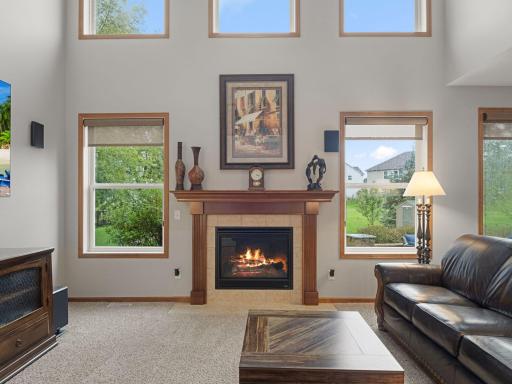 Great Room Fireplace â Gas fireplace anchors the soaring two-story great room, surrounded by windows that bring in abundant natural light.