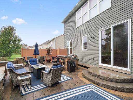 Backyard Patio â Expansive paver patio and outdoor kitchen create an exceptional space for outdoor entertaining.