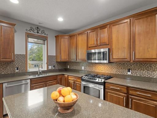 Kitchen â Generous kitchen features abundant cabinetry, extensive counter space, stainless steel appliances and a center island.