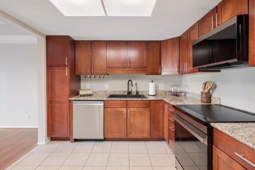 A second kitchen view highlights the generous cabinet space, expansive countertops, and functional layout.
