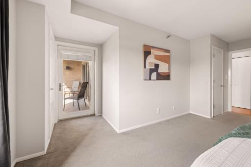 An additional bedroom view highlights the impressive floor space and convenient access to the private balcony.