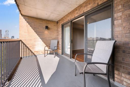 Your own outdoor escape! This spacious covered balcony offers room to relax, entertain, and enjoy the city scenery.