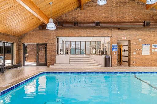 Indoor pool area with access to hot tub, sauna, and outdoor patio space.