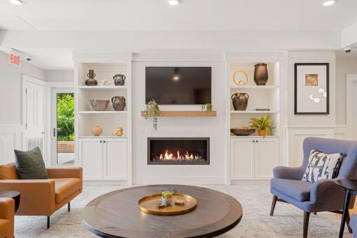 Community lounge fireplace with built-ins and stylish gathering space.