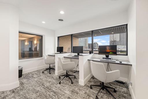 Business center with individual workstations, computers, and great natural light.