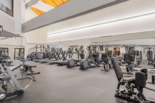 Fitness center with cardio equipment, mirrors, and updated workout areas.