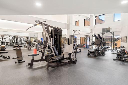 Large fitness center with strength-training equipment and open workout space.