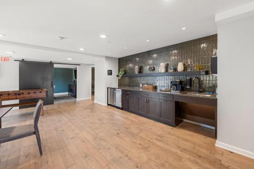 Community room wet bar and entertainment area with stylish updated finishes.