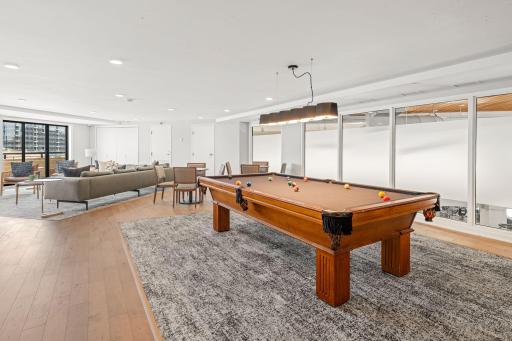 Newly remodeled community room with billiards, lounge seating, and gathering space.