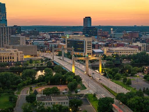 The city comes alive after sunset with beautiful views of the illuminated Hennepin Avenue Bridge and the Minneapolis skyline.