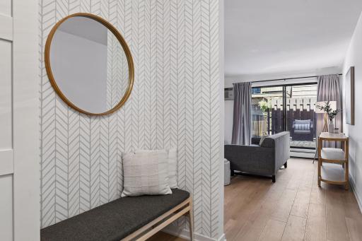 The front entry opens to a spacious family room with direct access to a large private outdoor patio.
