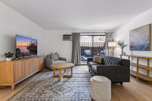 The large sliding glass door fills the space with natural light and provides easy access to the outdoor private patio.