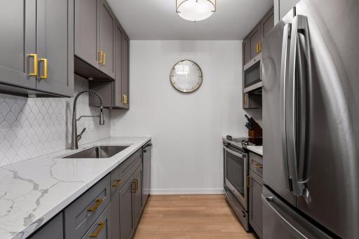 The kitchen is complete with brand-new stainless steel appliances.