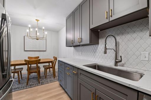 The kitchen opens to a charming dining area, creating an inviting space for everyday meals and entertaining.