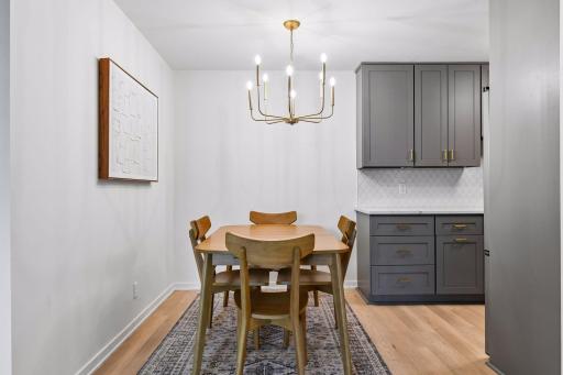 The dining area is finished with a stylish new light fixture.