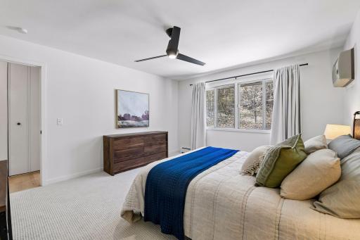 The primary bedroom feels fresh and inviting with new carpet, fresh paint, and new drapes.