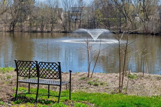 Enjoy peaceful views of the beautifully landscaped community pond.
