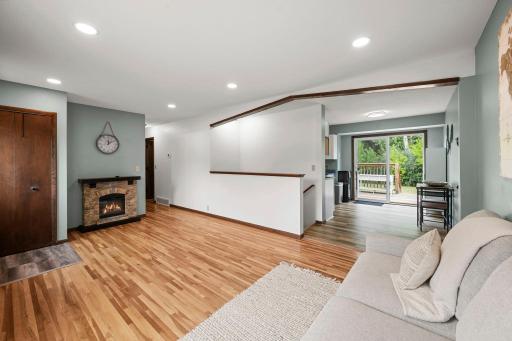 Open flow from living room to dining & kitchen with deck views