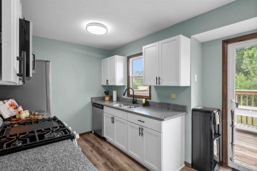 Efficient galley kitchen with sunny window & stainless appliances